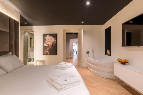a bedroom with a white bed and a bath tub at Brera Luxury Apartment near Duomo With Wifi in Milan