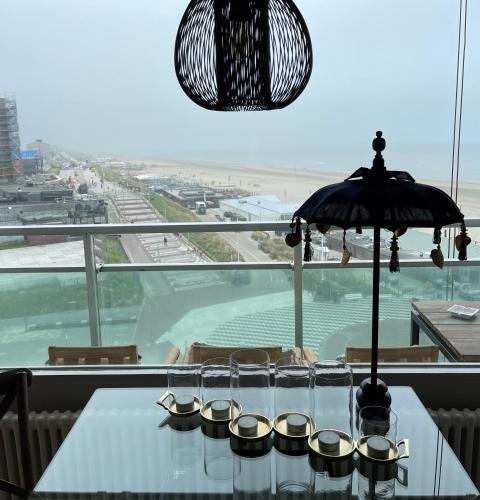a table with cupcakes on it with a view of the ocean at Apartment Pascalle in Zandvoort