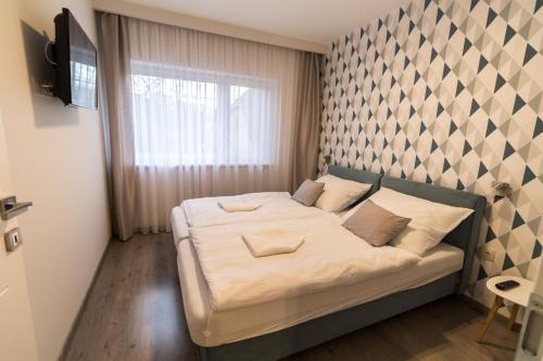 Ένα ή περισσότερα κρεβάτια σε δωμάτιο στο Thermal Lux Weninger Apartman