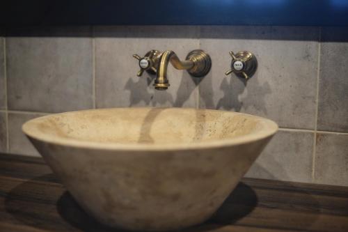 a sink with two faucets in a bathroom at Maison 1686 in Niedernai