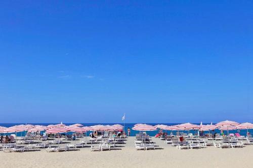 a group of chairs and umbrellas on a beach at Pizzo Beach Club in Pizzo