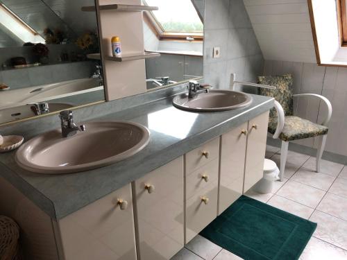 a bathroom with two sinks and a large mirror at Liorzh an ty in Kerfany-les-Pins
