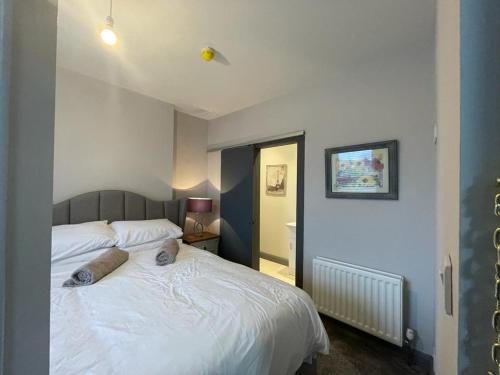 - une chambre avec un lit blanc et 2 oreillers dans l'établissement The Corner House. Derry City. 3 bed, sleeps 6., à Londonderry County Borough