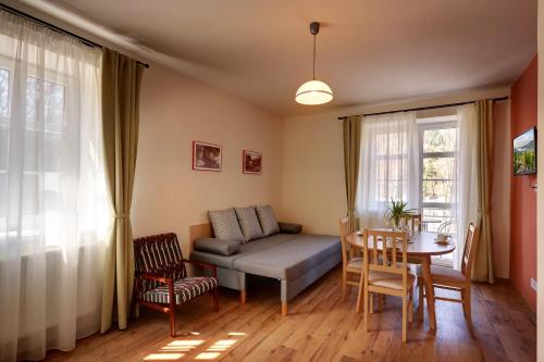 a living room with a couch and a table at Apartmány Tatra in Jáchymov