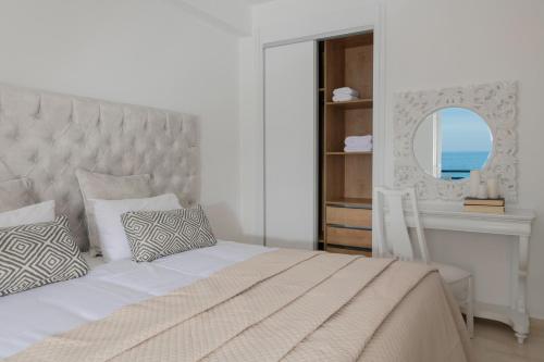 a bedroom with a bed and a desk and a mirror at Villa Bala - Seaside Luxury Villa! in Zakynthos Town
