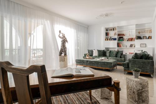a living room with a couch and a table with a book at Villa Bala - Seaside Luxury Villa! in Zakynthos Town
