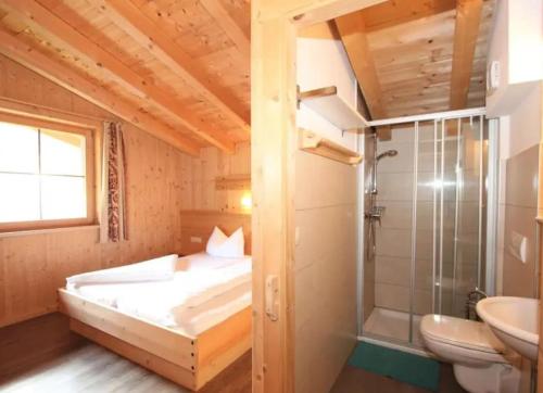 a bedroom with a bed and a shower and a sink at Alois & Elisabeth, Chalet in Tux