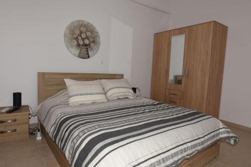 a bedroom with a bed and a mirror on the wall at Ηermes Apartment - 3 in Nafplio