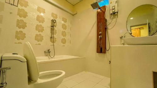 a bathroom with a toilet and a sink at Summer Vibes Beach Front in Rasdu