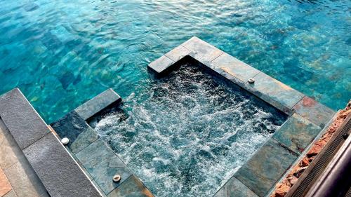 an empty pier in the water next to the ocean at Résidence U Pirellu in Porto-Vecchio
