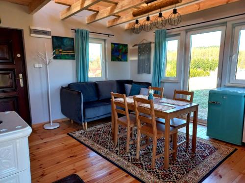 a living room with a table and a blue couch at Dom Malarki in Mirosławiec