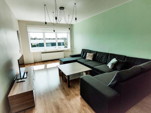 a living room with a couch and a table at Suur-Sepa apartment near city centre and beach in Pärnu