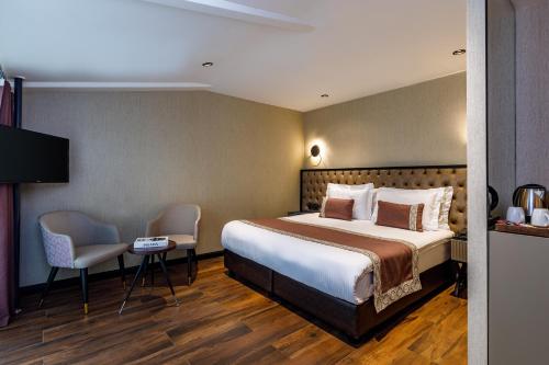 a hotel room with a bed and two chairs at Euro Design Hotel in Istanbul