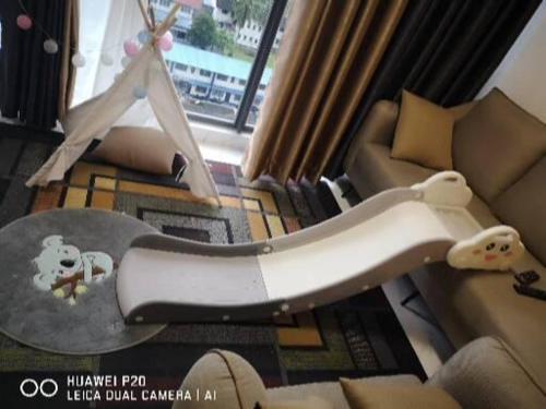 a skateboard in a living room next to a couch at Ammar @ Troika in Kota Bharu