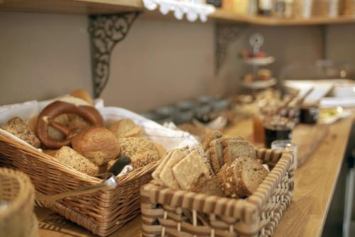 two baskets of bread sitting on a table at Pension & Seminarhaus "Haus am Fluss" in Laurenburg