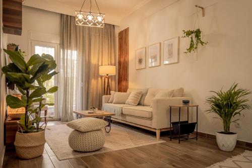 a living room with a couch and a table at Aphrodite's Apartment on Agia Sofia Midas Home in Thessaloniki