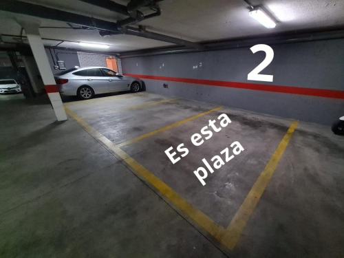 a parking lot with two cars in a parking garage at www Goyahospitales es Peñalba Parking incluido in León