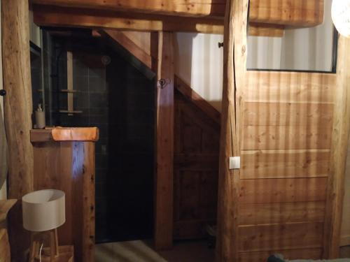 an open door to a room with wooden walls at CHALET ARLETTE in Les Orres