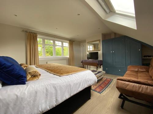 a bedroom with a bed and a chair and a window at Toadhall Rooms in Muchalls