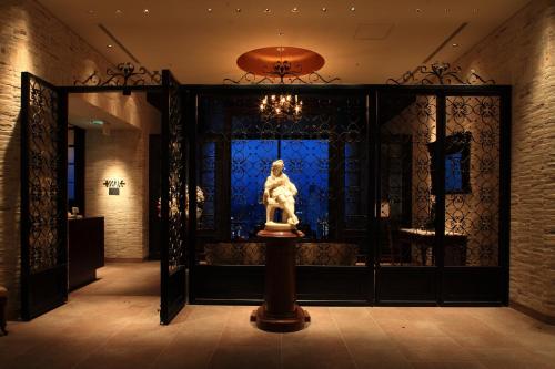 a statue of a woman in a room with a window at Hotel Monterey Grasmere Osaka in Osaka