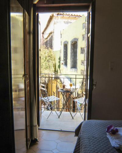 a room with a view of a balcony with a table at Casa Dasyra in Chania Town