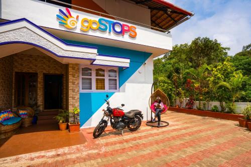a motorcycle parked in front of a store at goSTOPS Coorg in Madikeri