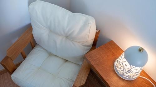 a bed with a white pillow next to a table at The Village House by CDV in Carrazeda de Anciães