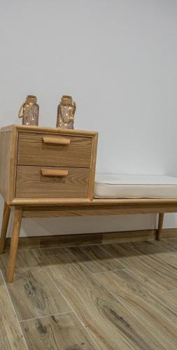 a wooden table with two vases on top of it at The Village House by CDV in Carrazeda de Anciães