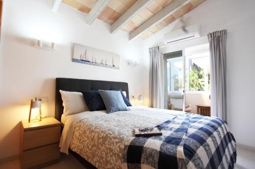 a bedroom with a bed and a window at Villa Beach Alcudia, lovely house with jacuzzi in Alcudia