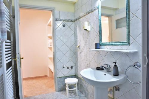 a bathroom with a sink and a shower with a mirror at Avra Milos in Zefiría