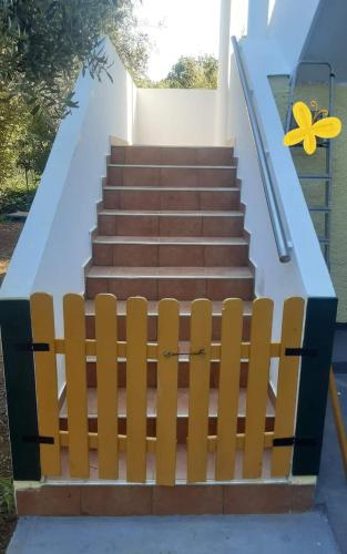 a set of stairs with a yellow flower on it at Apartments Nena 3* in Ližnjan
