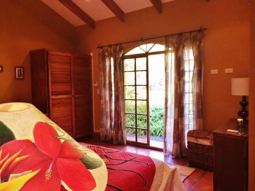 a bedroom with a bed and a large window at Unique 5 Architectural Homes, Pool & Wi-Fi in Lagunillas