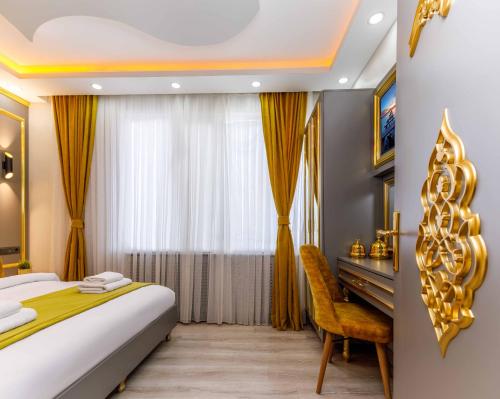 a bedroom with a bed and a desk and a window at Santa Rio Taxim in Istanbul
