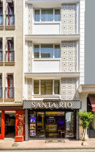 a tall white building with a store front at Santa Rio Taxim in Istanbul