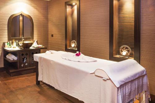 a bathroom with a bed with a sink and a mirror at Nidya Hotel Galataport in Istanbul