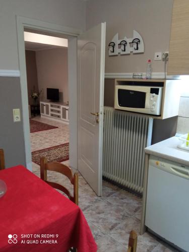 a kitchen with a table with a red table cloth at Apartments to nature A in Ámmos