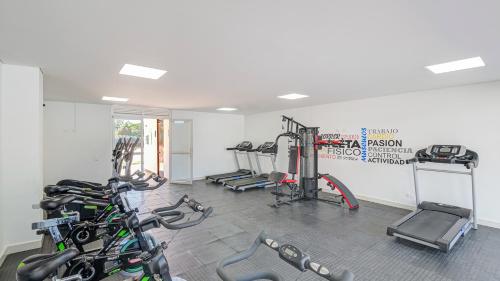 a gym with several treadmills and machines in a room at Peñazul La Aldea Condominio en Ricaurte Campestre - Apartamento con vista a piscinas in Ricaurte