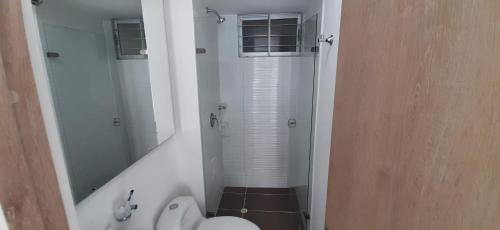 a bathroom with a shower and a toilet and a sink at Peñazul La Aldea Condominio en Ricaurte Campestre - Apartamento con vista a piscinas in Ricaurte