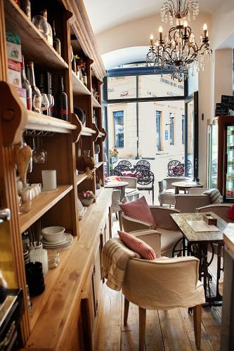 a dining room with tables and chairs and a chandelier at Jungmann Hotel in Prague