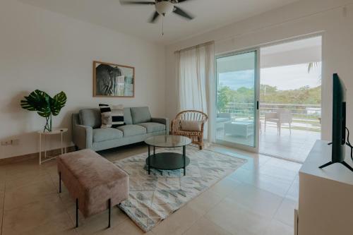 a living room with a couch and a table at Lumina at Jardines Punta Cana Village in Punta Cana