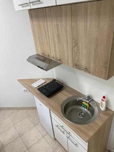 a kitchen with a sink and a counter top at Apartman Dunav in Kladovo