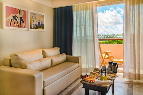 a living room filled with furniture and a window at Grand Palladium Imbassaí Resort & Spa - All Inclusive in Imbassai