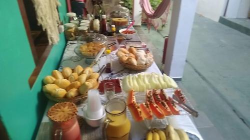 a long table filled with different types of food at Pousada do Cacau in Arraial d'Ajuda