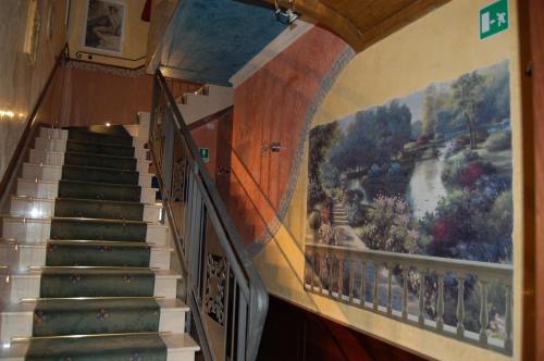 a staircase in a building with a painting on the wall at Sul Bacino in Massa Lombarda
