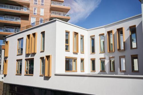 a facade of a building with yellow windows at Quality Hotel Grand Larvik in Larvik