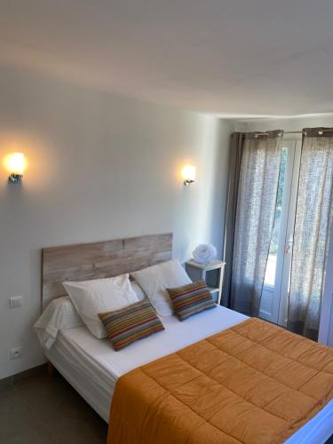 a bedroom with a large bed with an orange blanket at Valle Di Casa in Sotta