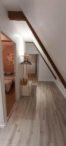 a attic room with a staircase with a ladder at Appartement dans maison de 1789 au centre de Vitré in Vitré