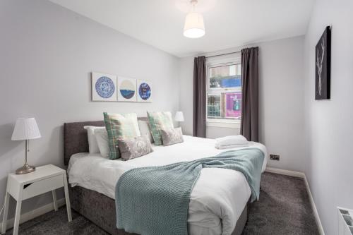 a bedroom with a bed and a window at Ayr Retreat - Donnini Apartments in Ayr