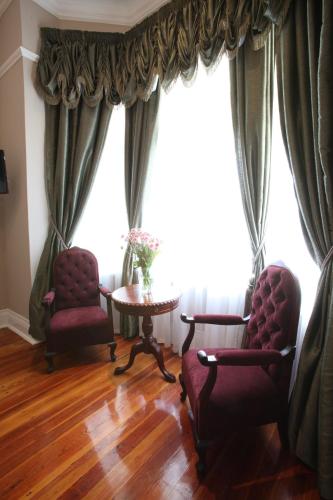 two chairs and a table in front of a window at Park Place Boutique Guesthouse in East London