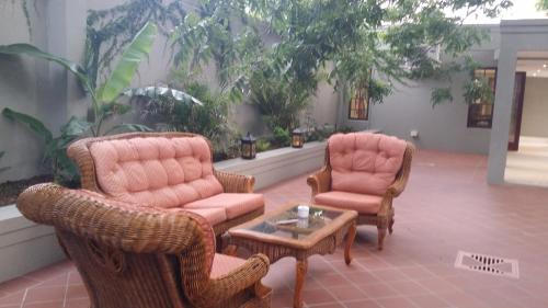 a living room with two chairs and a coffee table at Park Place Boutique Guesthouse in East London